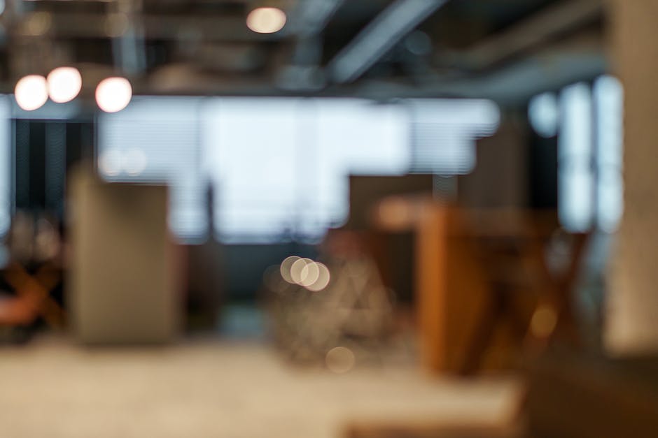 Defocused view of an office space with soft lighting and bokeh effects